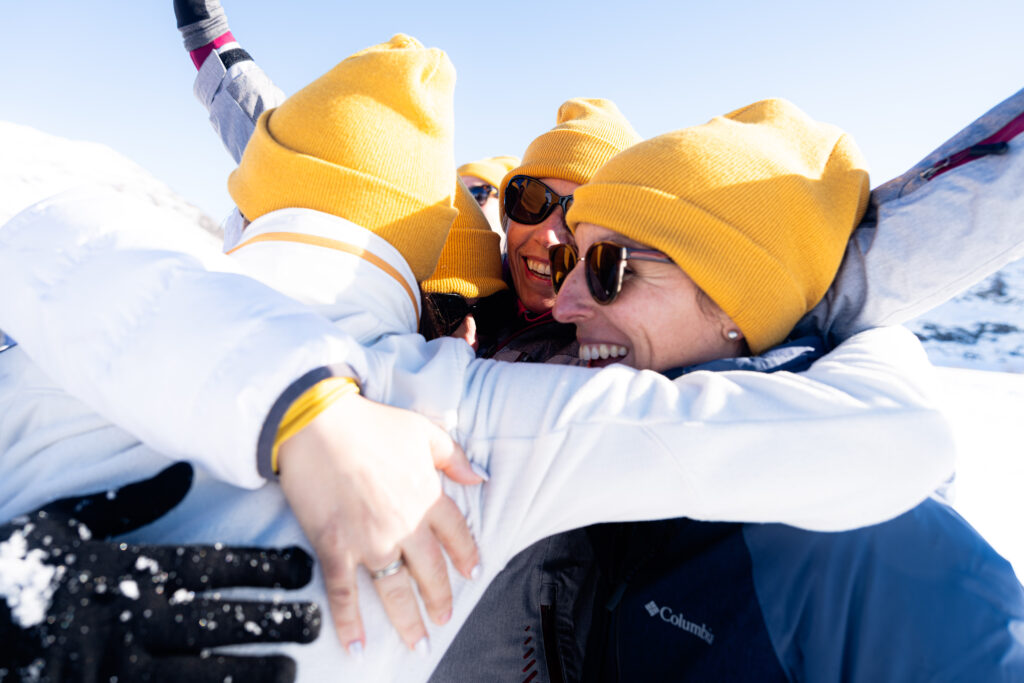 Team members celebrating together outdoors, showcasing teamwork and camaraderie at Voyage Privé.